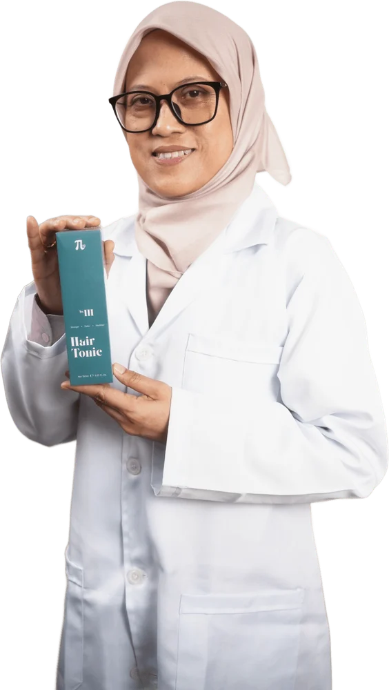 Assoc. Prof. Ir. Ts. Dr. Rosnani Hasham, the researcher behind T·Lab, holding the Hair Tonic